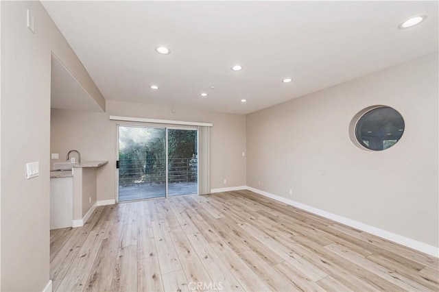 spare room with light hardwood / wood-style floors