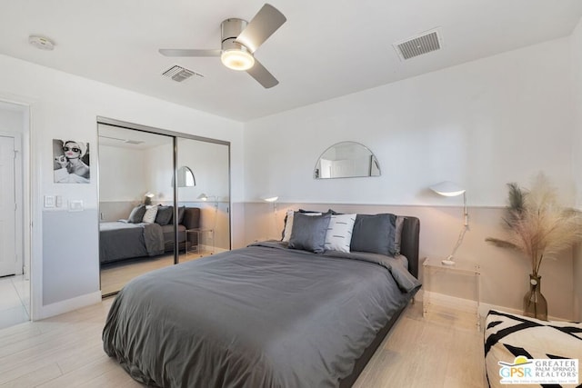 bedroom with ceiling fan, a closet, and light hardwood / wood-style floors