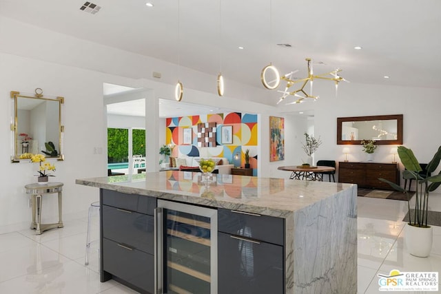 kitchen with light stone countertops, vaulted ceiling, a kitchen island, decorative light fixtures, and wine cooler