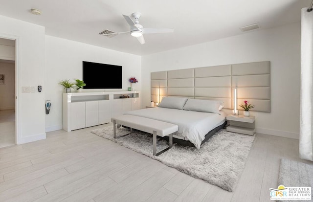 bedroom with ceiling fan and light hardwood / wood-style floors