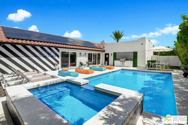 view of pool featuring a patio area and an outdoor kitchen