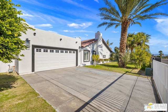 view of front of home featuring a front lawn and a garage