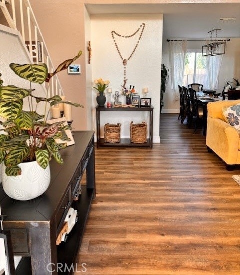 interior space featuring an inviting chandelier and dark hardwood / wood-style floors