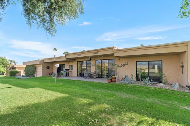 rear view of property featuring a patio area and a yard