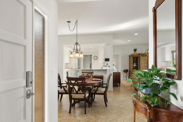 dining room featuring light tile patterned floors and an inviting chandelier