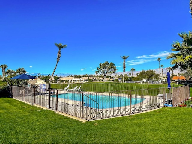 view of pool with a yard and a patio