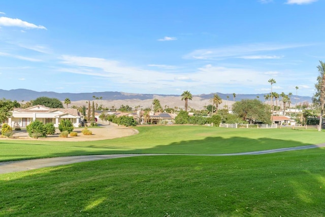 view of community featuring a lawn and a mountain view