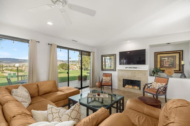 living room with ceiling fan and a healthy amount of sunlight