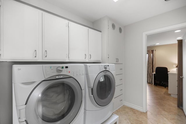 laundry room featuring cabinets, washing machine and dryer, and light tile patterned floors