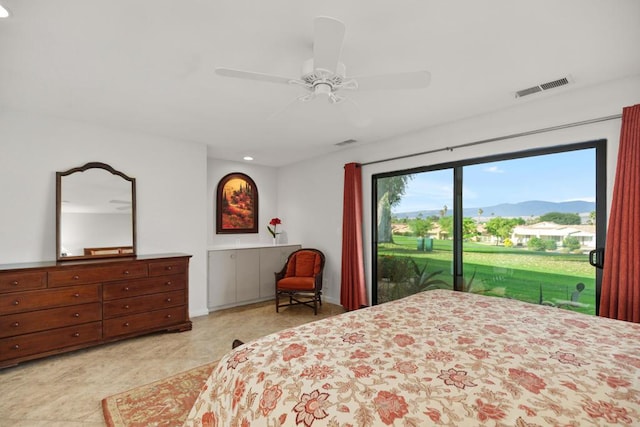 bedroom featuring access to exterior, a mountain view, and ceiling fan