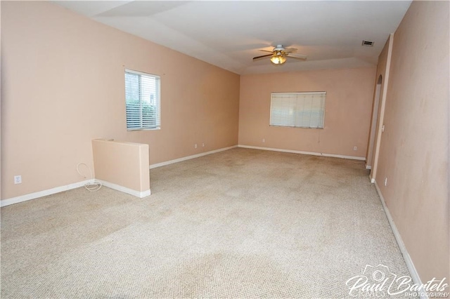 carpeted spare room featuring ceiling fan