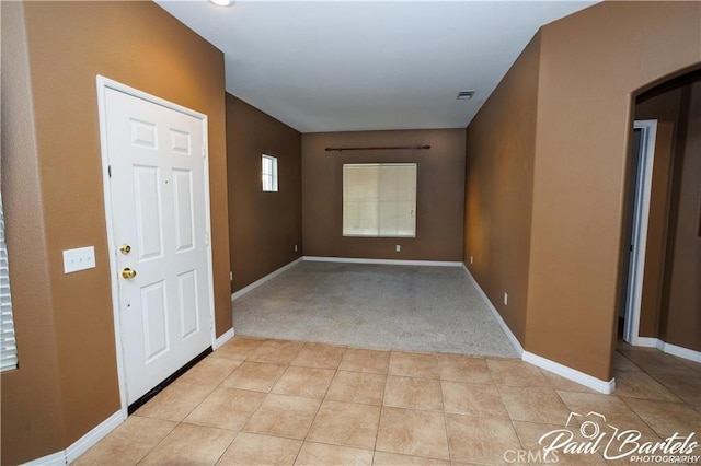 foyer with light colored carpet