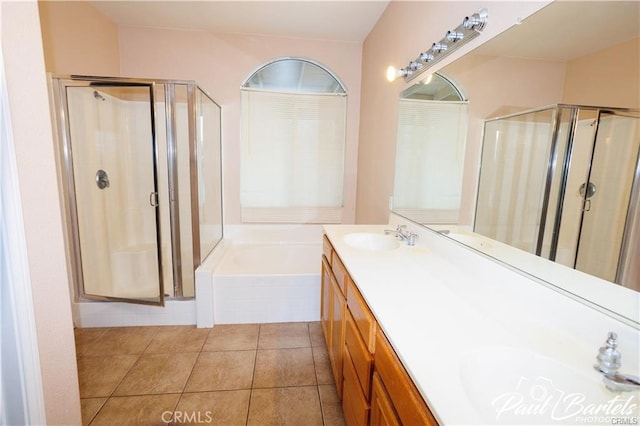 bathroom featuring vanity, plus walk in shower, and tile patterned floors