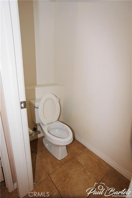 bathroom with toilet and tile patterned flooring