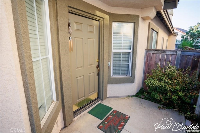 property entrance featuring a patio area