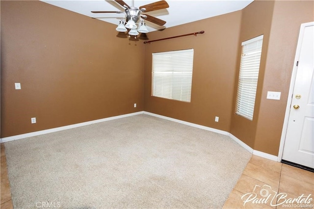 tiled empty room featuring ceiling fan