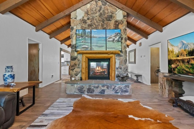 living room featuring high vaulted ceiling, a fireplace, wood-type flooring, and beamed ceiling