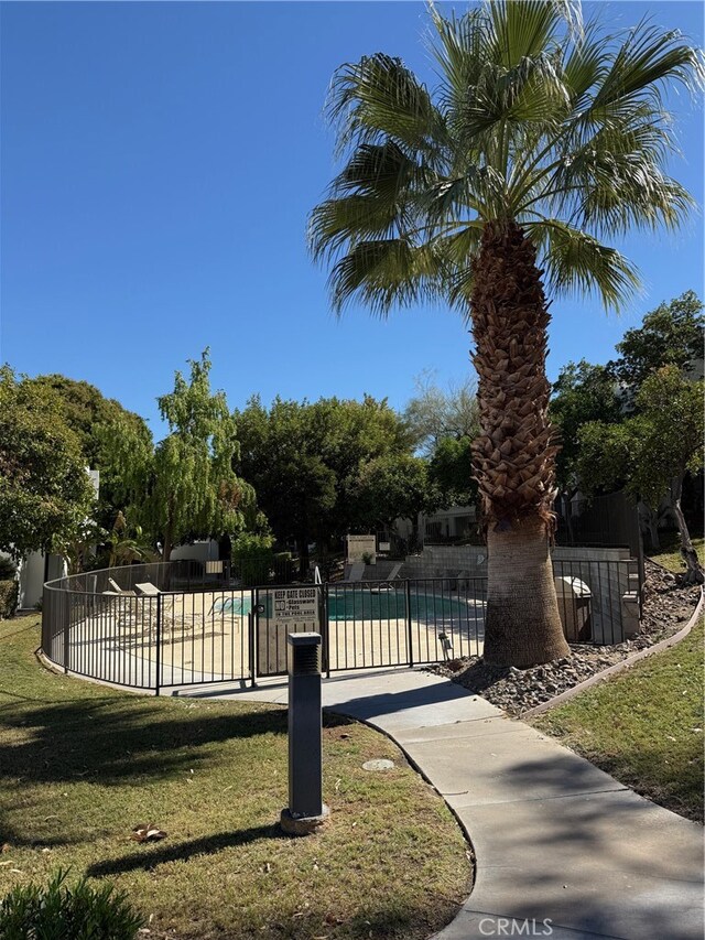 view of swimming pool featuring a lawn