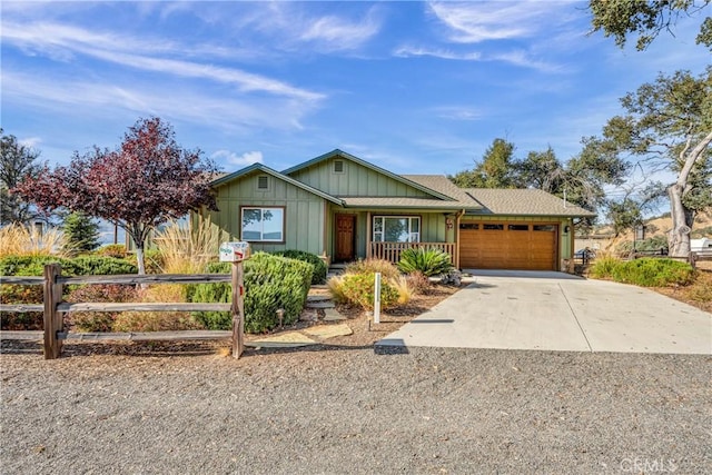 ranch-style home featuring covered porch and a garage