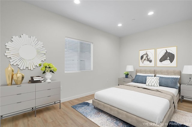 bedroom featuring baseboards, light wood finished floors, and recessed lighting