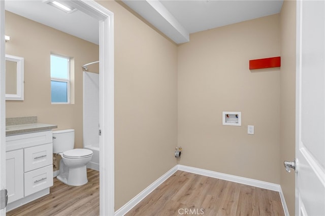 washroom with light wood-style floors, baseboards, and washer hookup