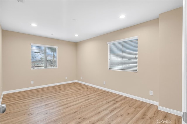 spare room with light hardwood / wood-style flooring