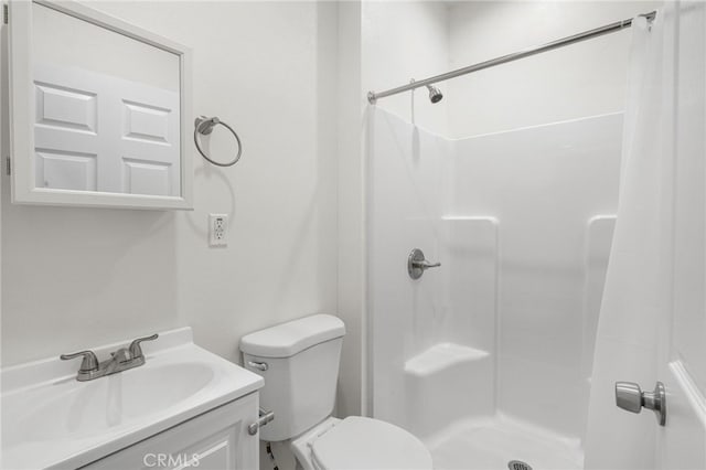 bathroom with toilet, a shower, and vanity