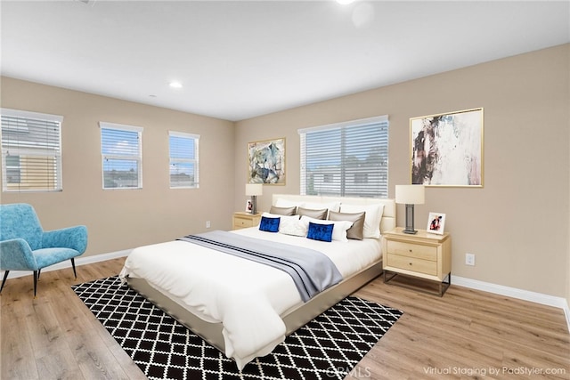 bedroom featuring light wood-type flooring, baseboards, and recessed lighting