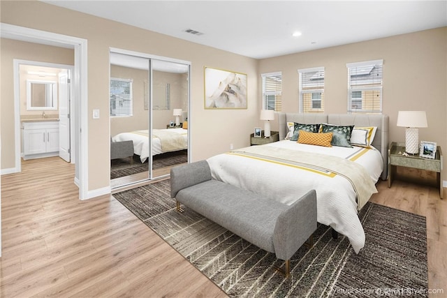 bedroom with baseboards, visible vents, light wood-style flooring, a closet, and recessed lighting