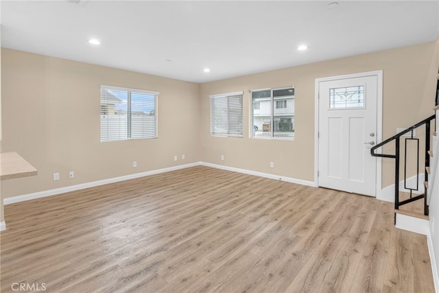 entrance foyer featuring recessed lighting, baseboards, light wood finished floors, and stairs