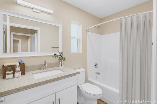 bathroom with toilet, shower / tub combo, and vanity