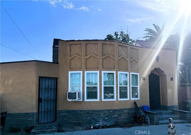 view of front facade featuring cooling unit