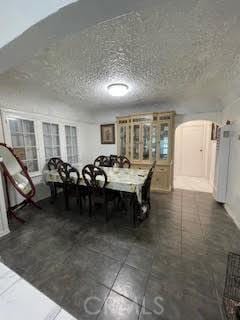 dining area featuring a textured ceiling