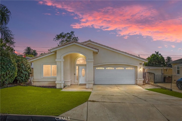 view of front of property with a yard and a garage