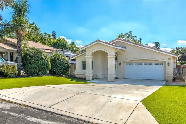 mediterranean / spanish house featuring a front yard and a garage