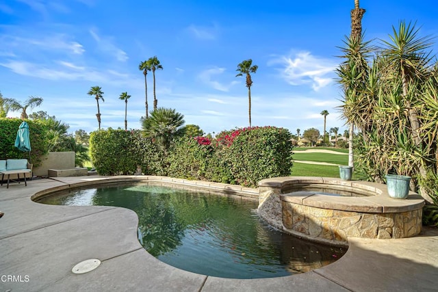 view of swimming pool with an in ground hot tub