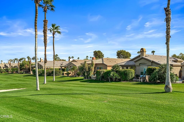 view of home's community featuring a lawn