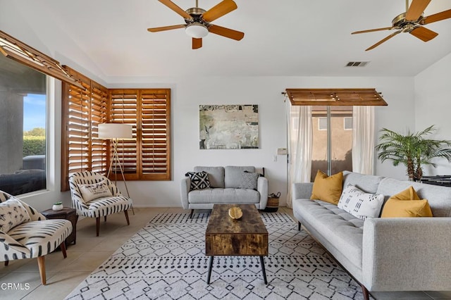 tiled living room featuring ceiling fan