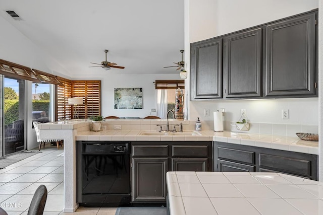 kitchen with a wealth of natural light, tile counters, light tile patterned floors, and black dishwasher