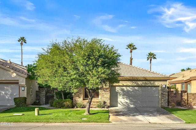 view of front of property featuring a garage and a front yard