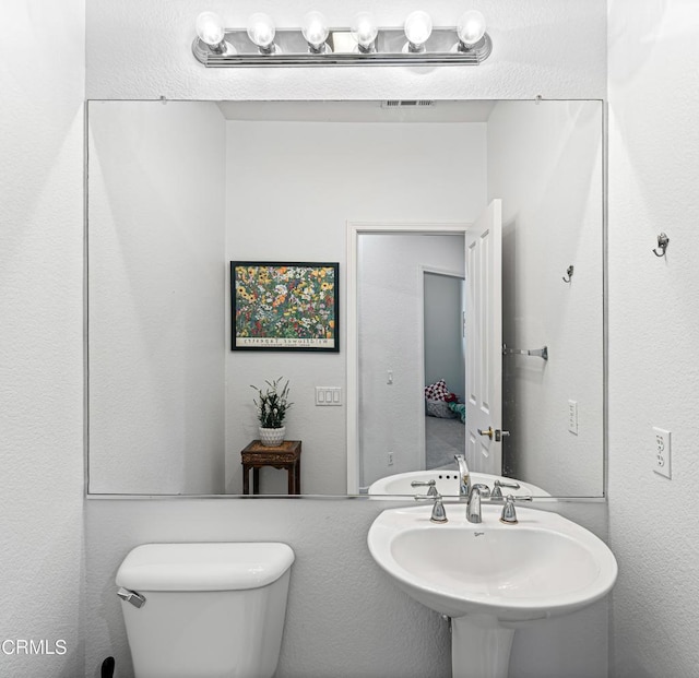 bathroom featuring sink and toilet