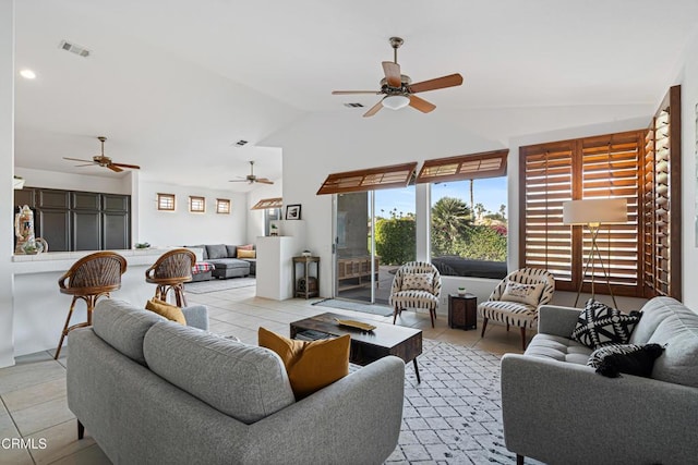 tiled living room with ceiling fan and vaulted ceiling