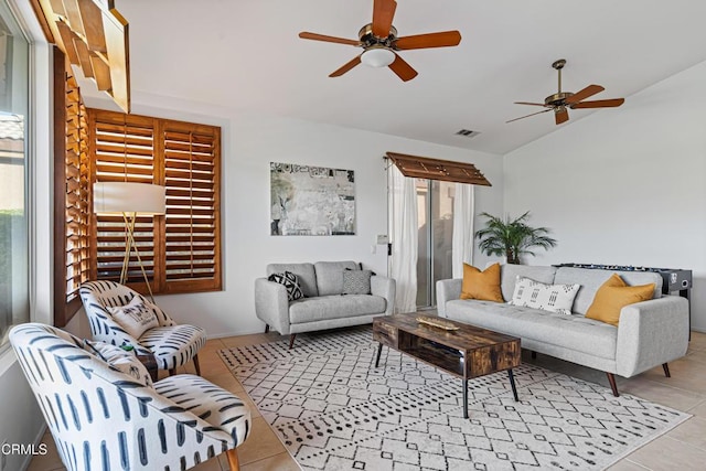 tiled living room featuring ceiling fan and lofted ceiling