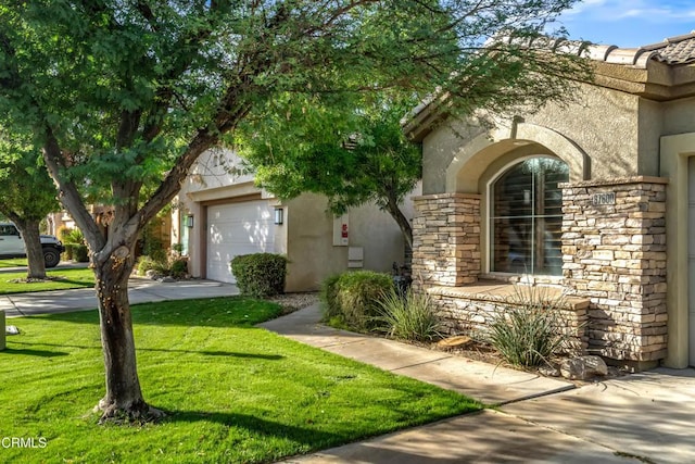 view of front of property with a front yard and a garage