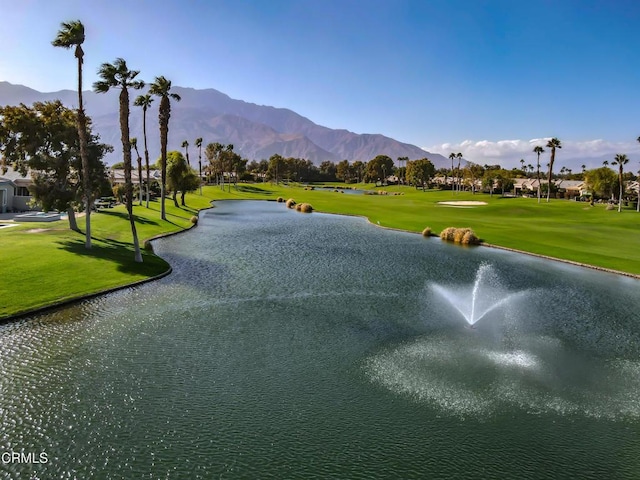 view of property's community featuring a yard and a water and mountain view