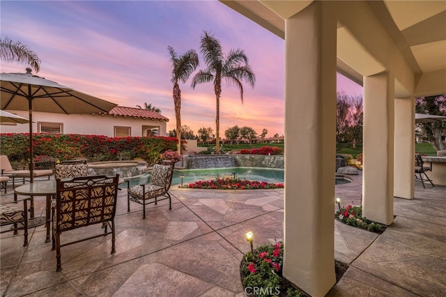 view of patio terrace at dusk