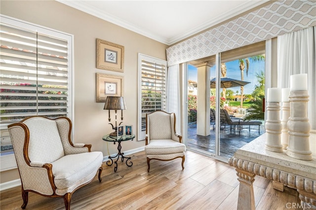 living area featuring light hardwood / wood-style flooring and ornamental molding