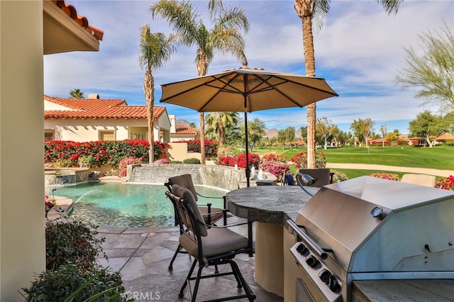 view of patio featuring pool water feature, area for grilling, and a grill