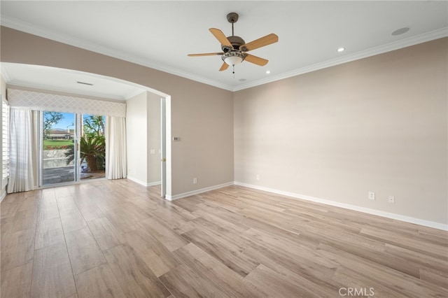 spare room featuring light hardwood / wood-style floors, ceiling fan, and crown molding