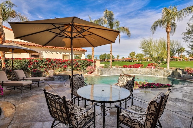 view of patio with pool water feature and a swimming pool with hot tub